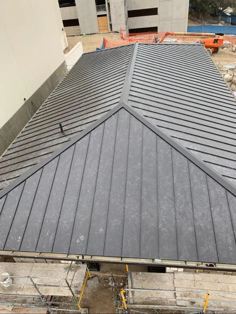 Commercial metal roof construction with crane equipment in Roselle