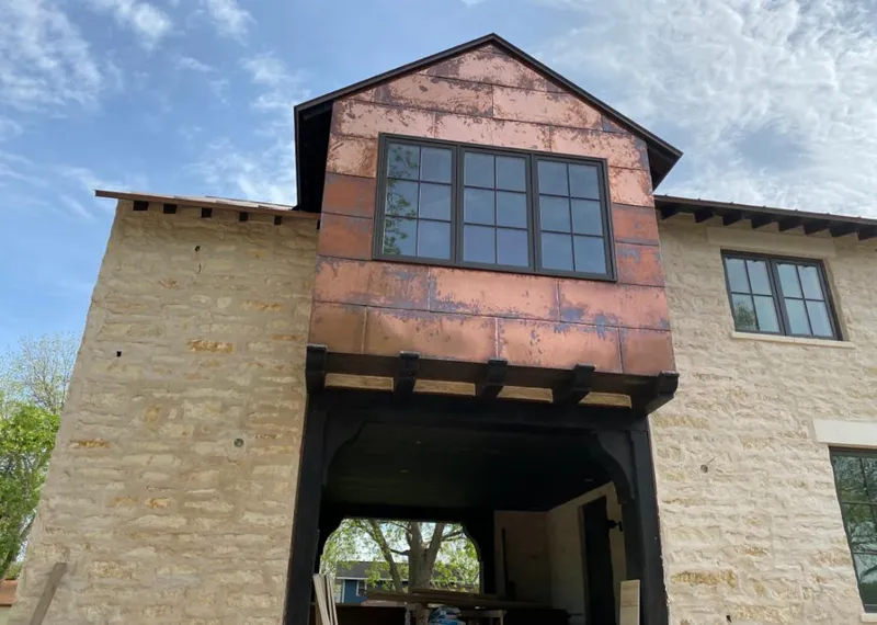 Copper metal panel facade on a stone building for Skylight Installation in Roselle
